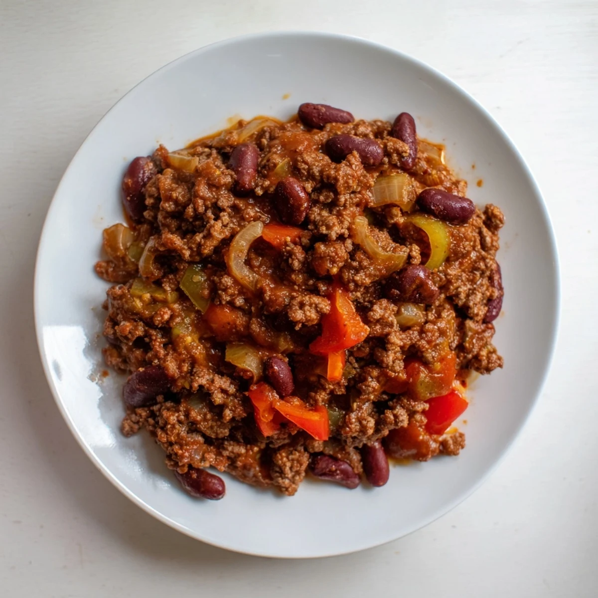 The dark, rich colors of this slow cooker beef & shallot chili suggest a hearty, flavorful meal.