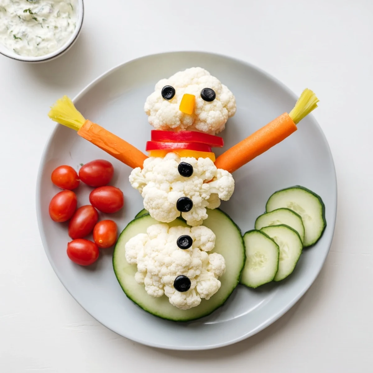 Snowman crudités with dip: A festive and fun appetizer with colorful vegetable snowman and creamy dip.