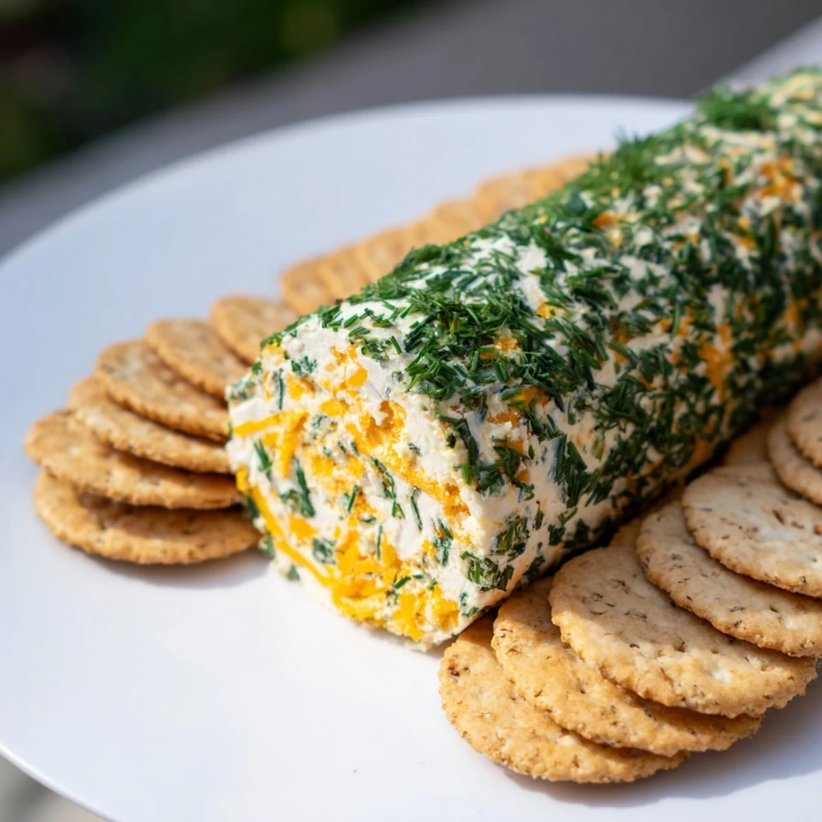 This Herb-Coated Cheese Log showcases creamy cheese and zesty herbs, perfect for a party appetizer.