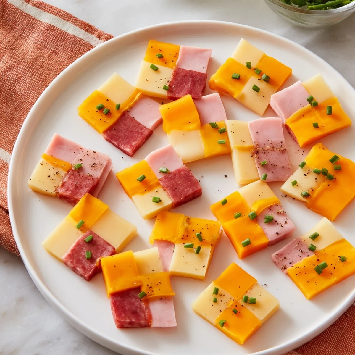 Vibrant checkerboard picnic bites, featuring squares of meat and cheese, perfect for a sunny picnic.