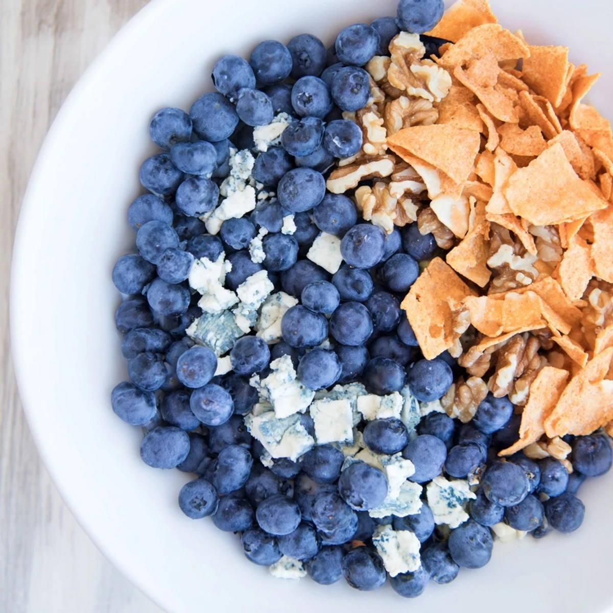 A close-up view of The Olympic Rings Interlock, showcasing fresh fruits, vegetables, and dips in five interlocking circles.
