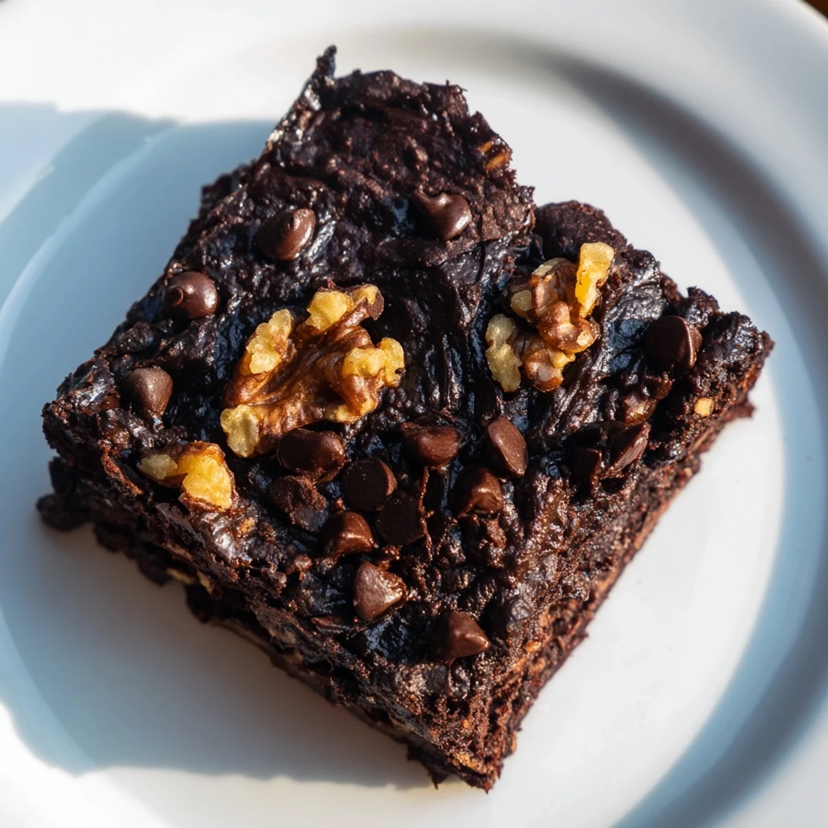 A close-up of dark, decadent black bean brownies, perfectly baked and promising a rich, flourless treat.