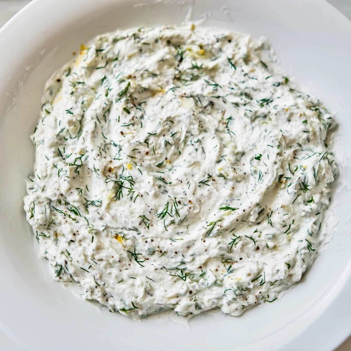 A vibrant bowl of creamy Greek yogurt herb dip, perfect for dipping fresh veggies.