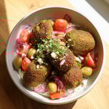 Crispy falafel nestles in a Festive Falafel & Tzatziki Christmas Wreath Wrap, ready to be enjoyed.