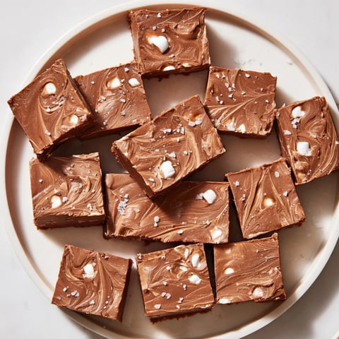 A glistening square of 5-Minute Marshmallow Fudge, offering a velvety texture and rich chocolate aroma.