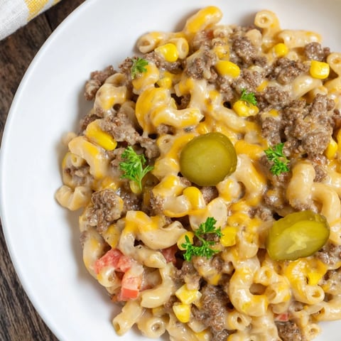 Cheesy Viral Cheeseburger Casserole Skillet bubbling in a large skillet, topped with melted cheddar cheese.
