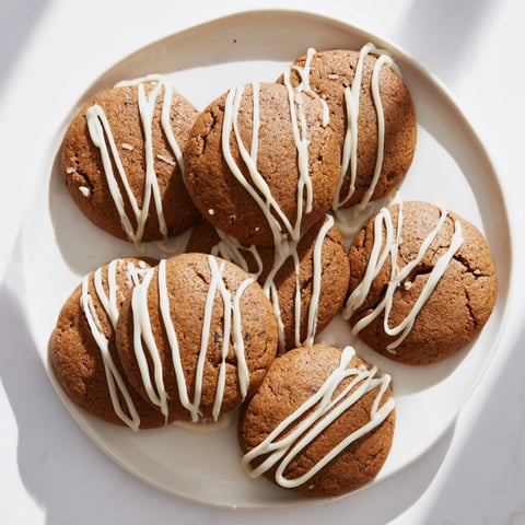 Warm, spiced gingerbread latte cookies drizzled with white chocolate, perfect for a treat!