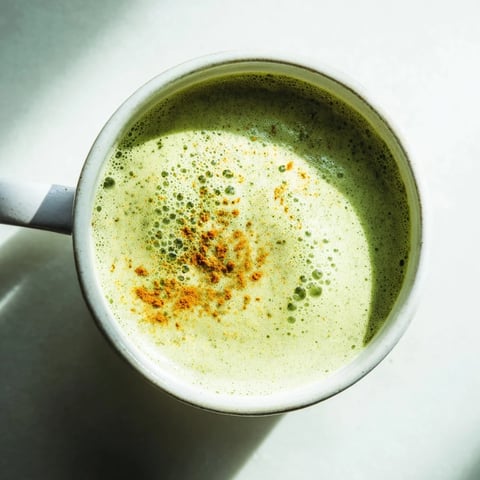 Steaming Coconut Ginger Matcha Winter Immunity Latte, a vibrant green beverage, waiting to be enjoyed.