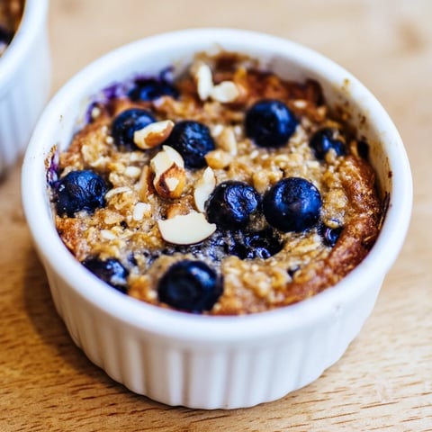 Warm baked Blueberry Baked Oats, golden brown and topped with juicy, plump blueberries ready to serve.
