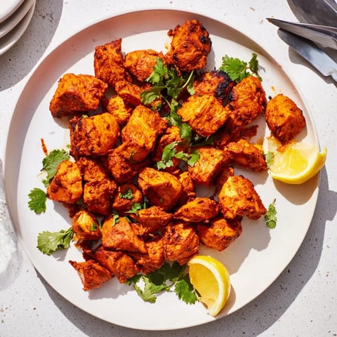 Golden-brown Indian Tikka Spiced Chicken thighs roasted with aromatic tandoori spices and served with fresh cilantro.