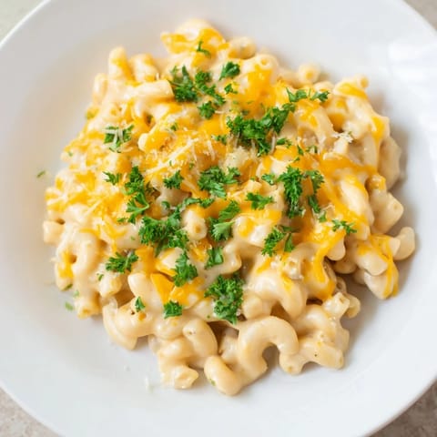 Creamy, veggie-packed one-pot butternut squash mac & cheese, topped with fresh parsley for serving.