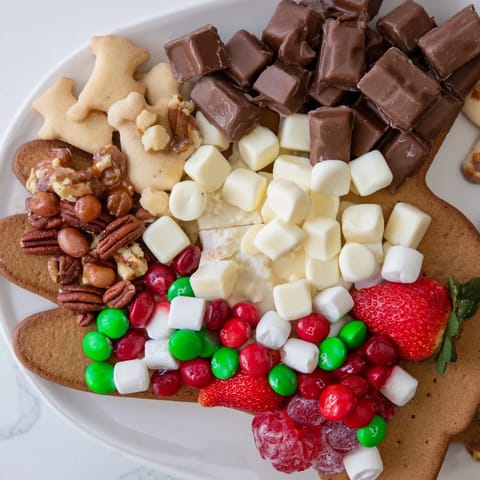A beautifully arranged Cozy Mitten Dessert Board showcases colorful fruits and sweet treats for winter enjoyment.