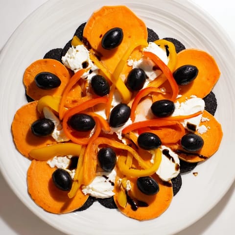Artfully displayed Monarch Butterfly Wings appetizer features colorful orange, black, and green ingredients.