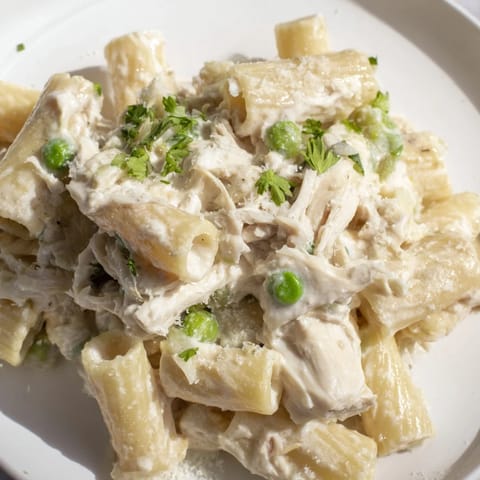 This photo features a comforting bowl of Slow Cooker Chicken Alfredo Pasta Bake with a cheesy, rich sauce.