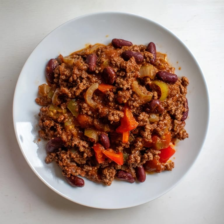 The dark, rich colors of this slow cooker beef & shallot chili suggest a hearty, flavorful meal.