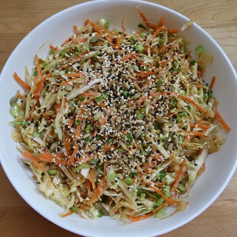 Close-up of a refreshing Cabbage-Core Slaw Salad, a colorful mix of crunchy vegetables and toasted seeds.