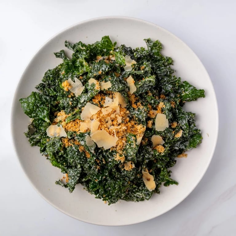 Savory Garlic Parmesan Kale Salad served fresh with crisp panko breadcrumbs, a creamy lemon-garlic dressing, and shaved Parmesan for a vibrant lunch.
