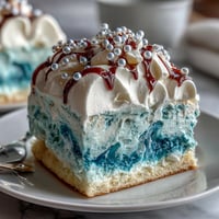 Pisces Cake Sheet Cake with Ocean Wave Piping in blue ombré buttercream, decorated with edible pearls and white chocolate Pisces symbol.